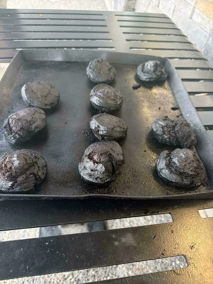 Burnt cookies on a baking tray showing cooking failure