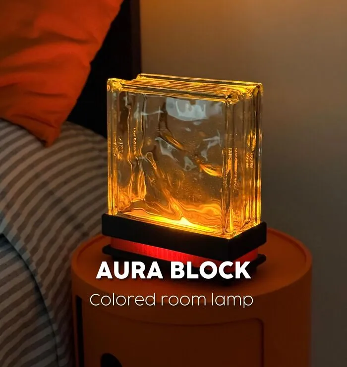 3D printed aura block colored room lamp glowing on a bedside table