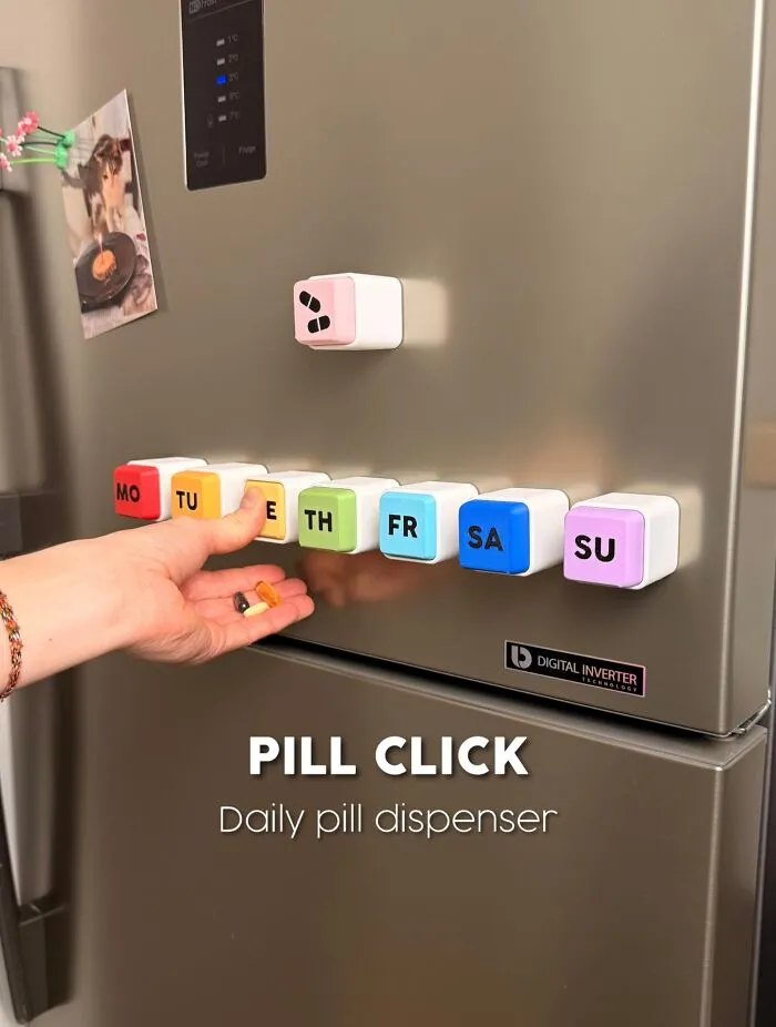 3D printed daily pill dispenser cubes arranged on refrigerator door