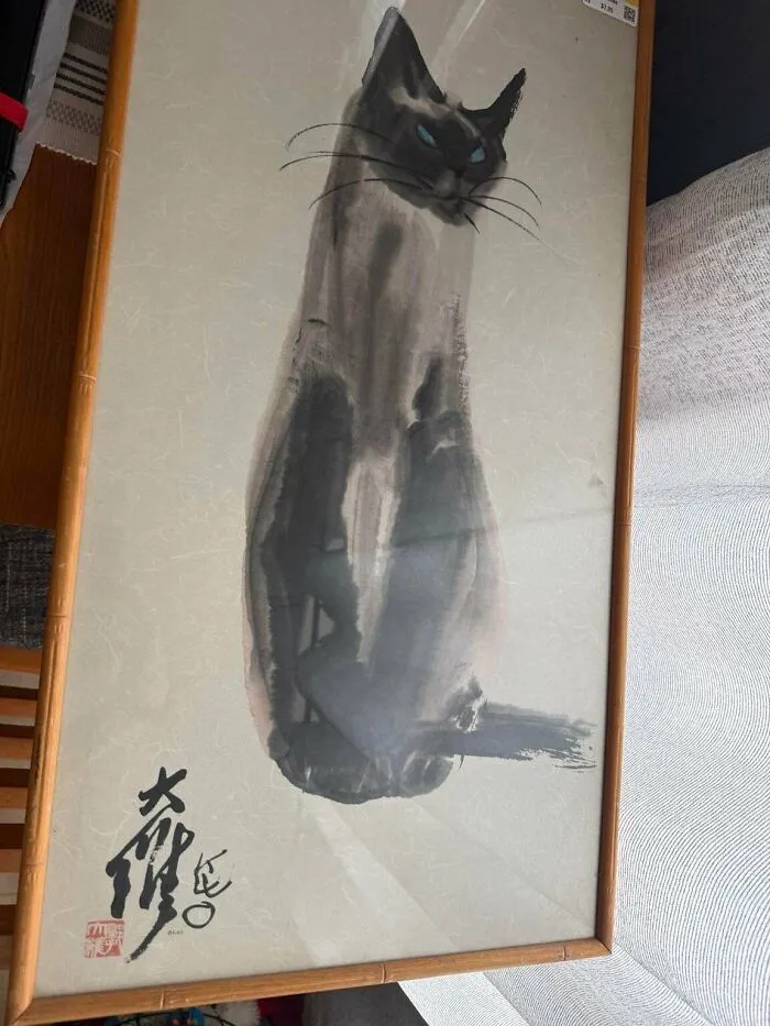 A framed watercolor painting of a Siamese cat, found while looking for thrift store finds