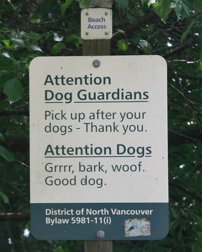A beach sign with instructions for dog guardians and funny dog barks, displaying humorous signs