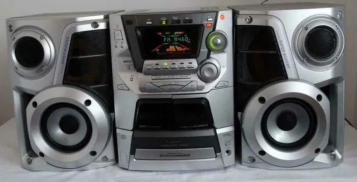 A silver retro CD changer stereo system with dual speakers popular in the early 2000s.