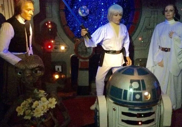 Star Wars wax figures including a misshapen alien and an R2-D2 model