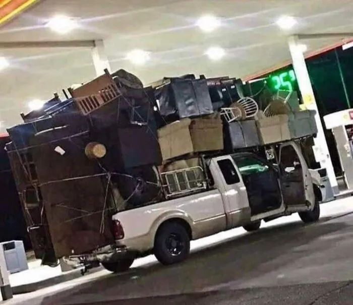 Pickup truck at gas station overloaded with furniture in moving fails pics