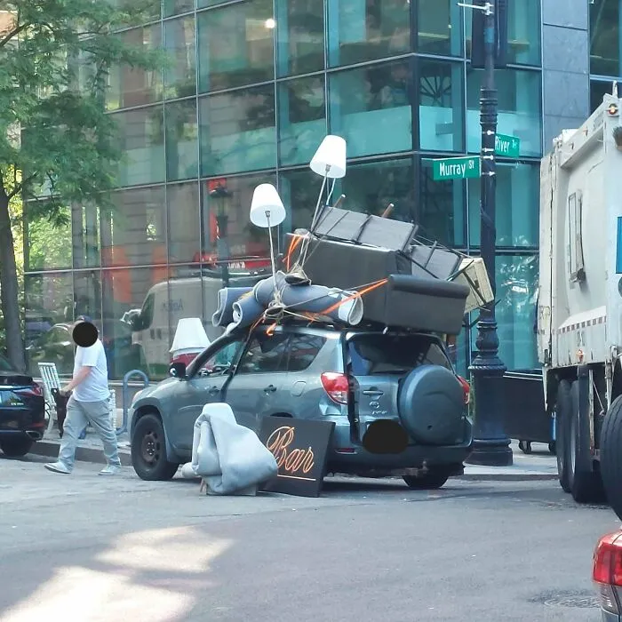 Car overloaded with furniture and lamps tied to roof during moving fails