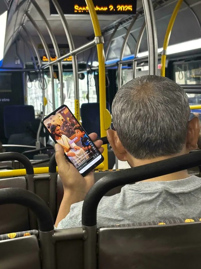 A man watching a video of Jesus on his phone, showing odd public transport interactions.