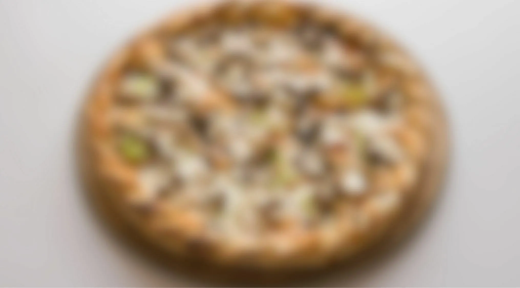 Blurry images eyesight trivia quiz featuring an unclear pizza on white background