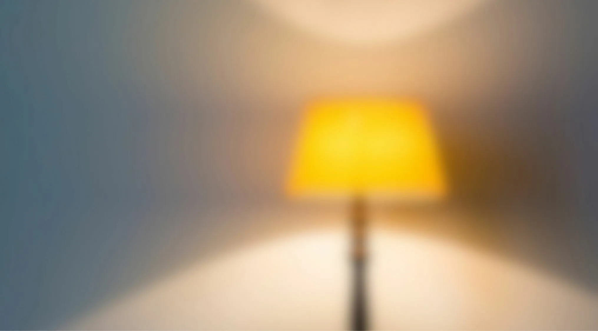 Blurry image of a lamp with yellow shade