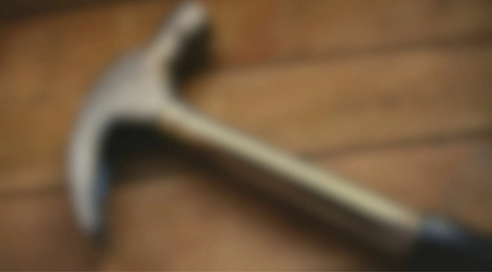 Blurry image of a hammer on wood surface eyesight trivia quiz