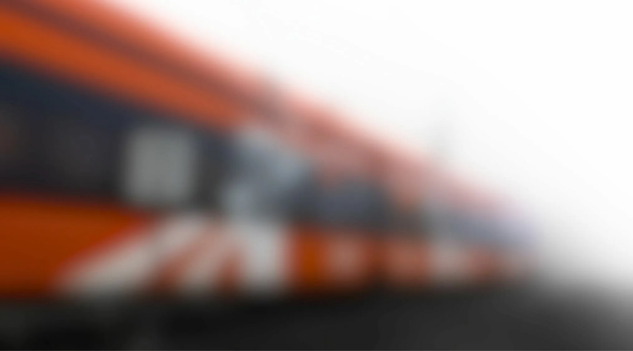 Blurred image of an orange train in motion