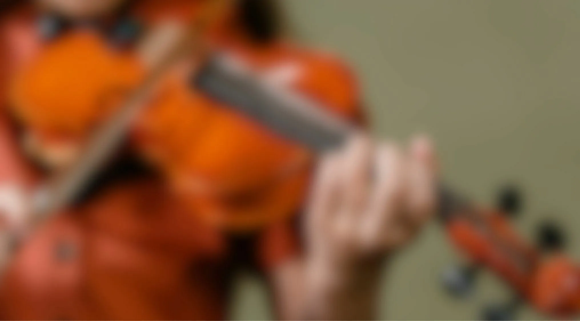Blurry image of person playing violin close up