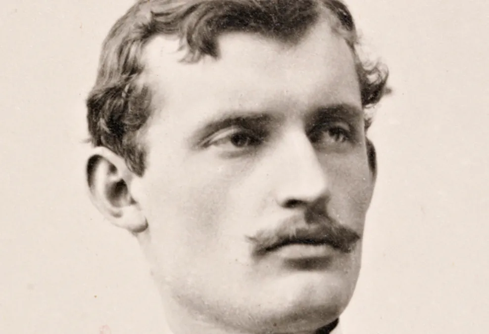 Sepia-toned portrait photograph of young artist Edvard Munch with wavy hair and a mustache