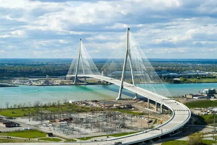 Large cable-stayed suspension bridge spanning a wide waterway, representing modern infrastructure design.