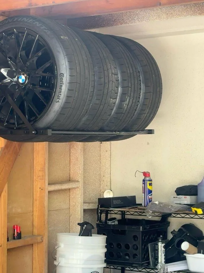 A sturdy overhead tire rack installed on a garage wall, showcasing smart DIY home upgrades.