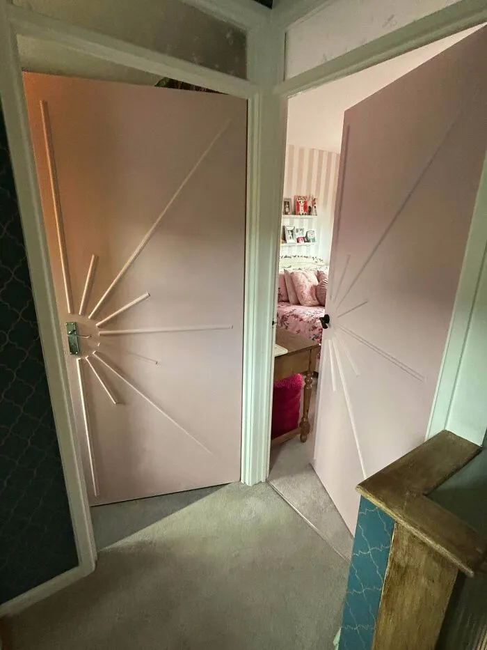 Two doors painted pink with an elegant starburst design, showing a creative DIY home upgrade