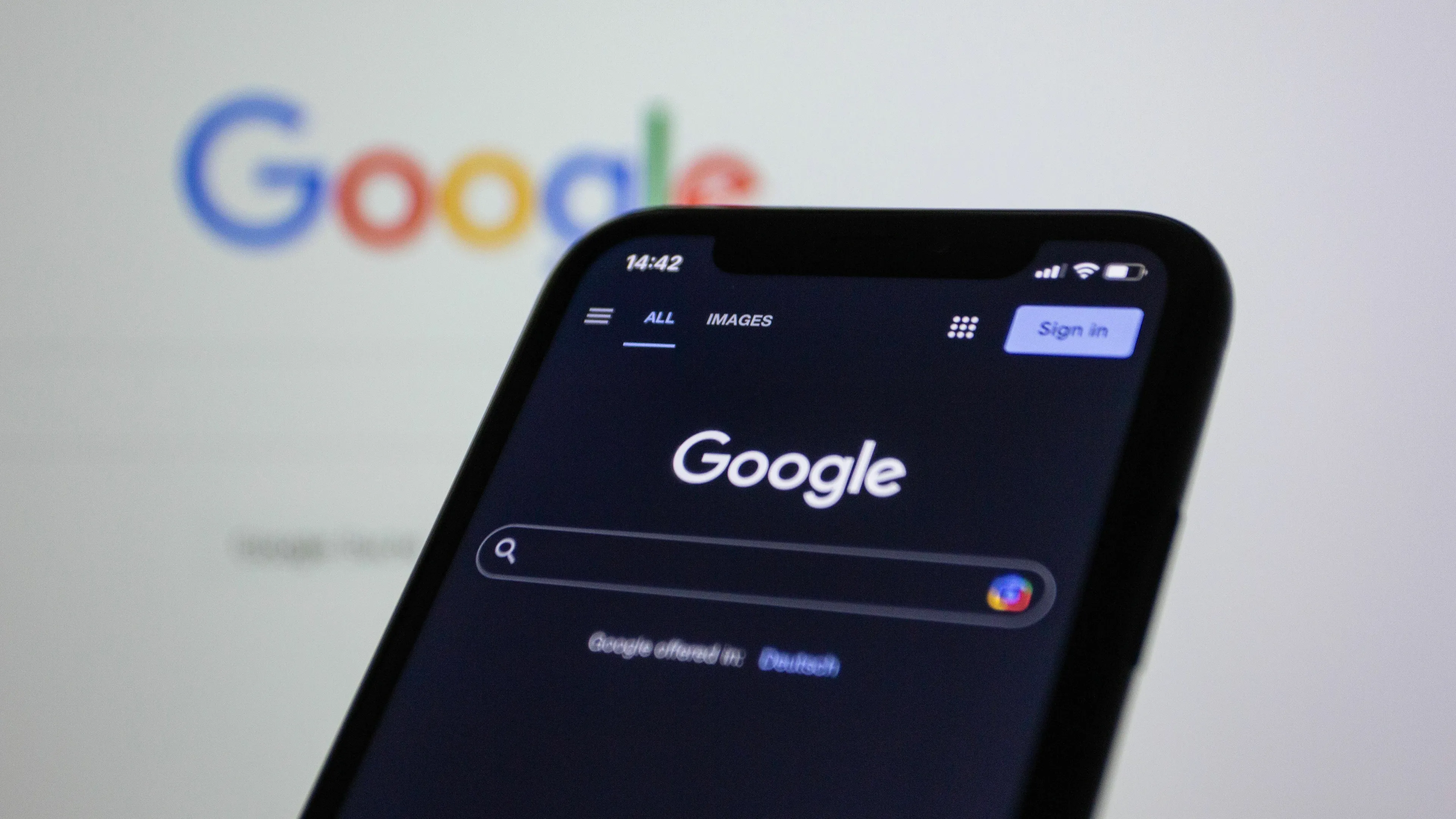 A smartphone showing the Google search engine screen, highlighting the original name of Google query