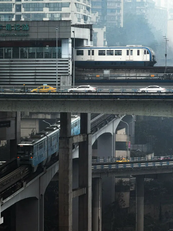 Multilevel transit bridges in an urban area with trains and cars representing complex world infrastructure