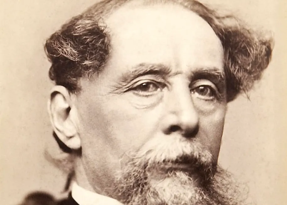 A sepia-toned portrait photograph of the famous English writer Charles Dickens.
