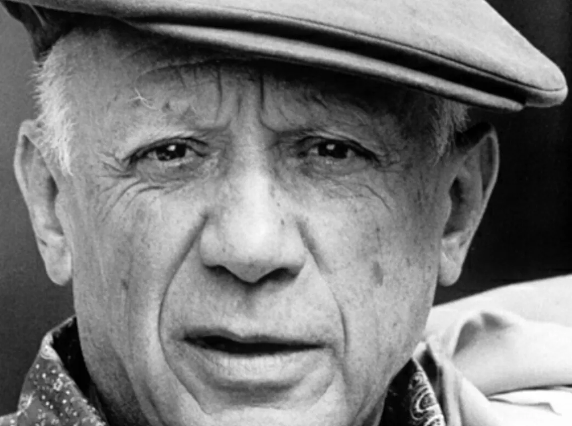 Black and white portrait of artist Pablo Picasso wearing a flat cap