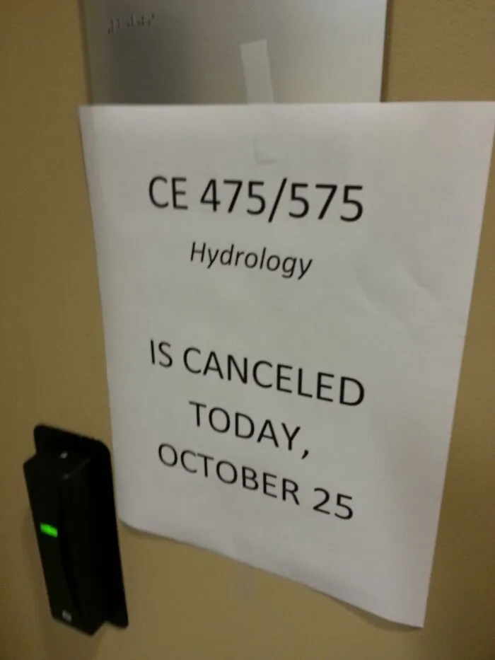 A printed sign on a university door from teachers showing that a Hydrology class is canceled on October 25.