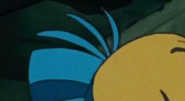 An extreme zoom-in of a yellow and blue Disney side character, Flounder from The Little Mermaid.