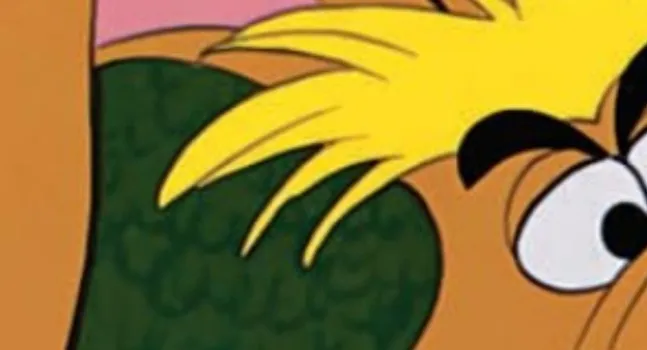 An extreme zoom-in of a Disney character with yellow hair, thick black eyebrows, and wide eyes.
