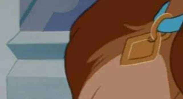 An extreme zoom-in of a Disney character wearing a blue collar with a gold diamond-shaped tag.
