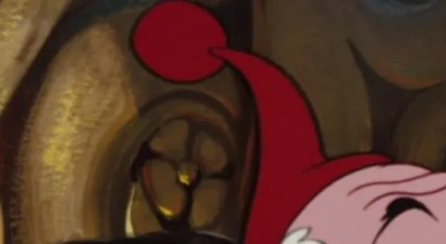 Extreme zoom-in of a Disney character wearing a red pointed cap with a pom-pom.