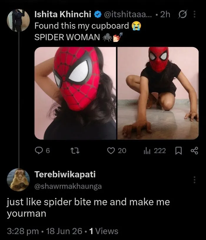 Person wearing Spider Woman mask posing with starry-eyed lovers spider theme