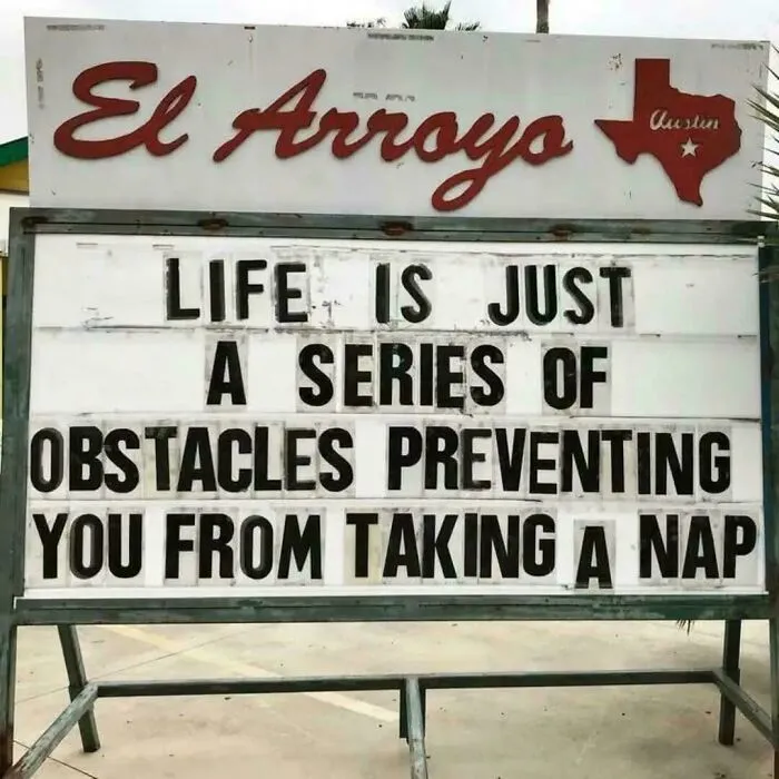 Humorous sign about life obstacles on restaurant board El Arroyo