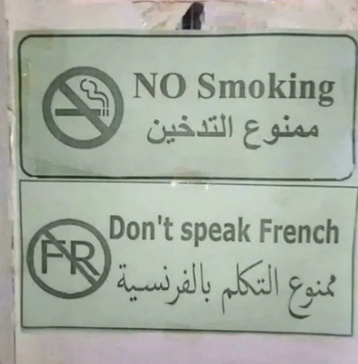 Funny sign prohibiting smoking and speaking French with symbols and bilingual text