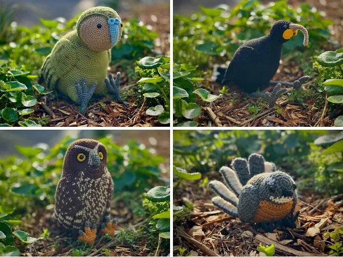 Four crocheted bird plushies in green, black, brown, and gray sitting outdoors among plants