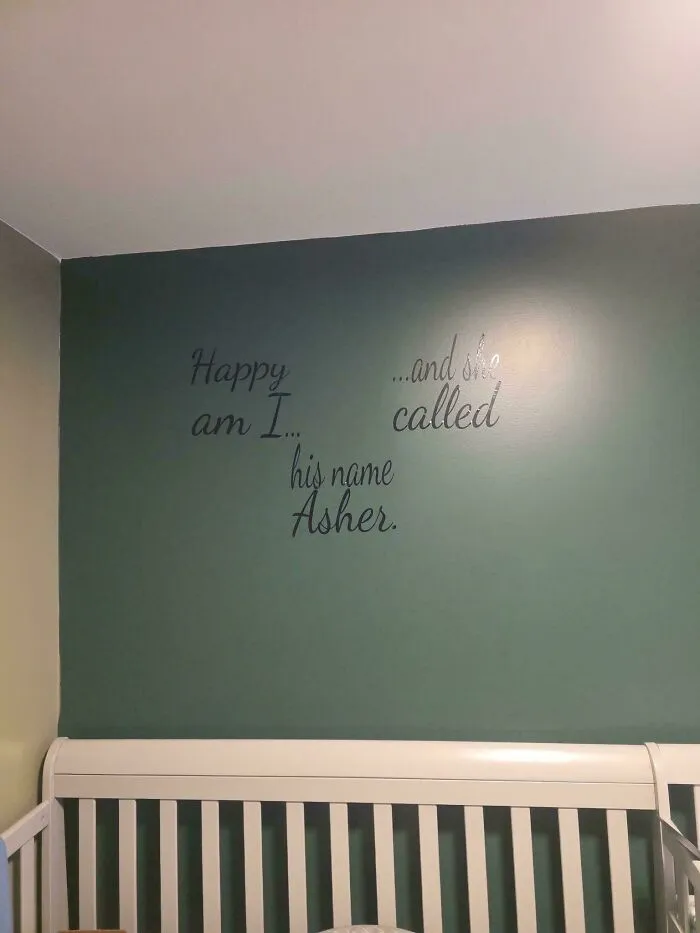 A poorly spaced quote painted on a green wall of a nursery, depicting houses with confusing design visions
