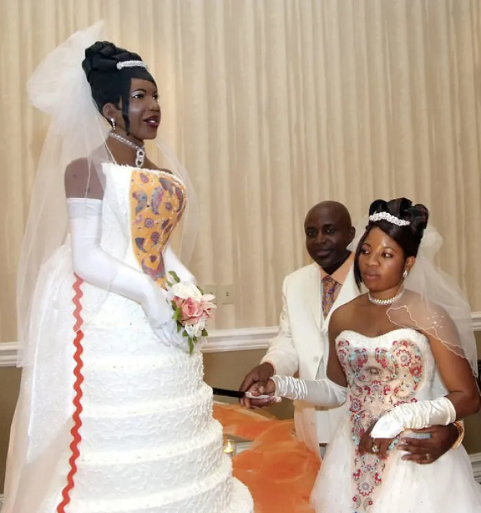 Bride cuts a life-sized cake of herself, showing ultimate main character energy on her wedding day.