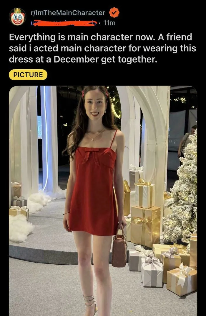 Woman in a red dress standing next to Christmas gifts, showing main character lives vibes at a holiday party.