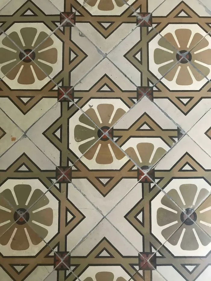 Mismatched and incorrectly rotated geometric floor tiles showing a clear design fail.