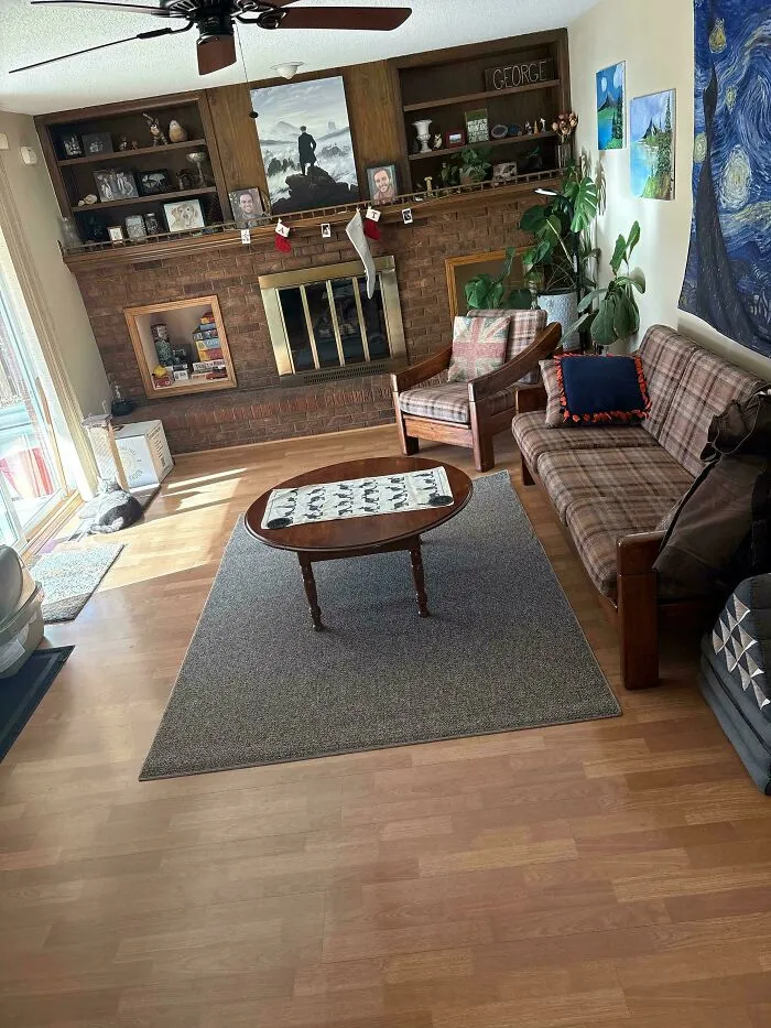 A cozy living room with a brick fireplace and wooden shelves, showing unique interior choices in various houses.
