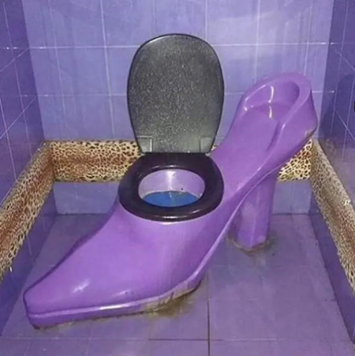 A purple toilet shaped like a high-heeled shoe showcasing a big vision interior design