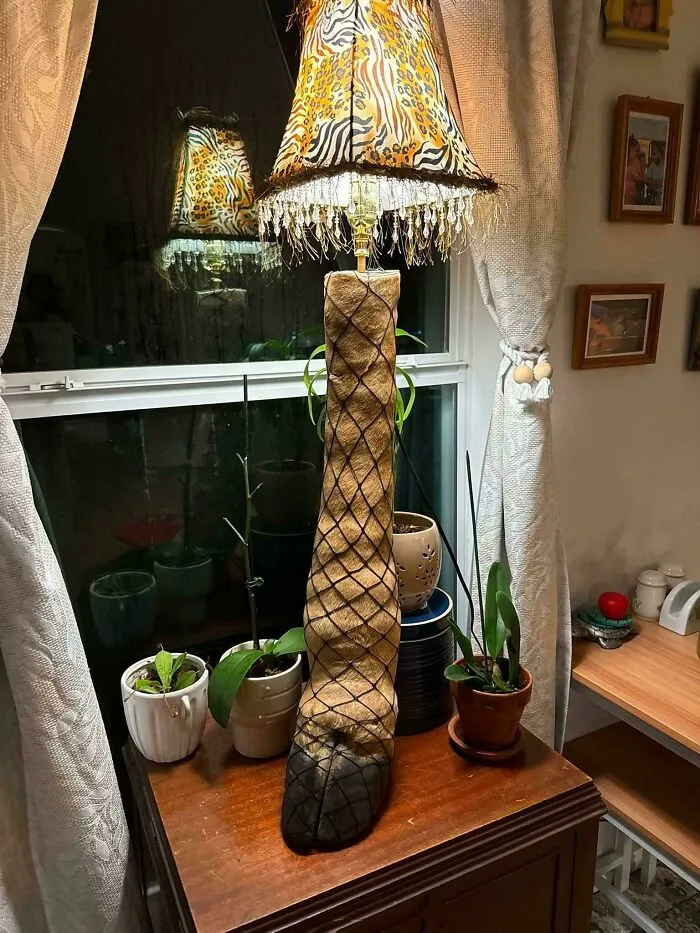A lamp made from a taxidermy deer leg wearing fishnets as a big vision home decor piece