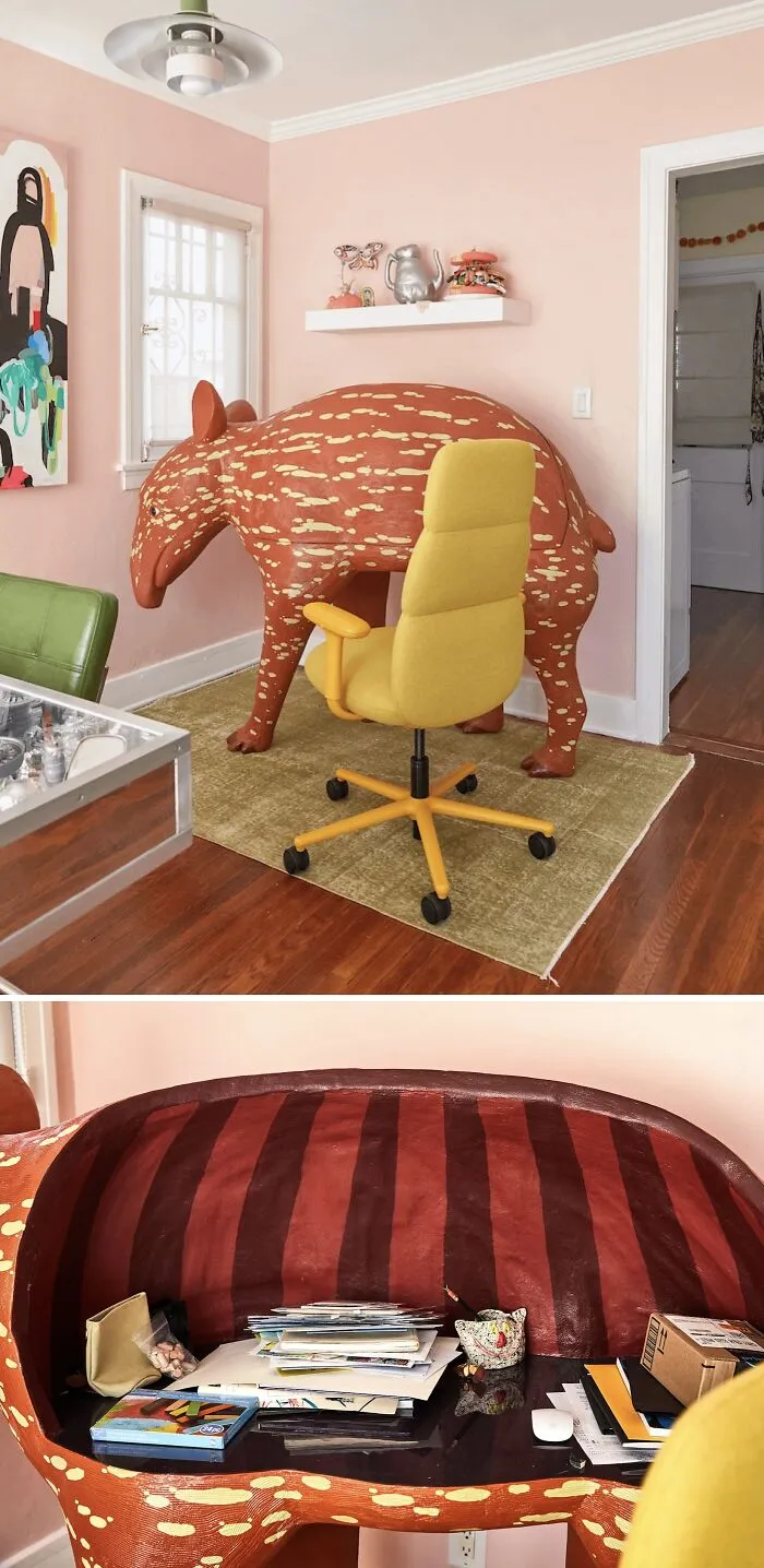 A large spotted animal sculpture serving as an office desk, highlighting unusual furniture in modern houses.