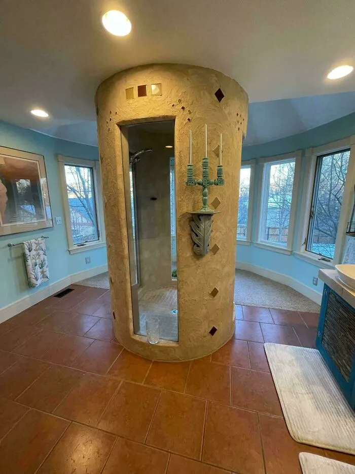 An unusual circular shower in the center of a room, highlighting houses designed with a vision.