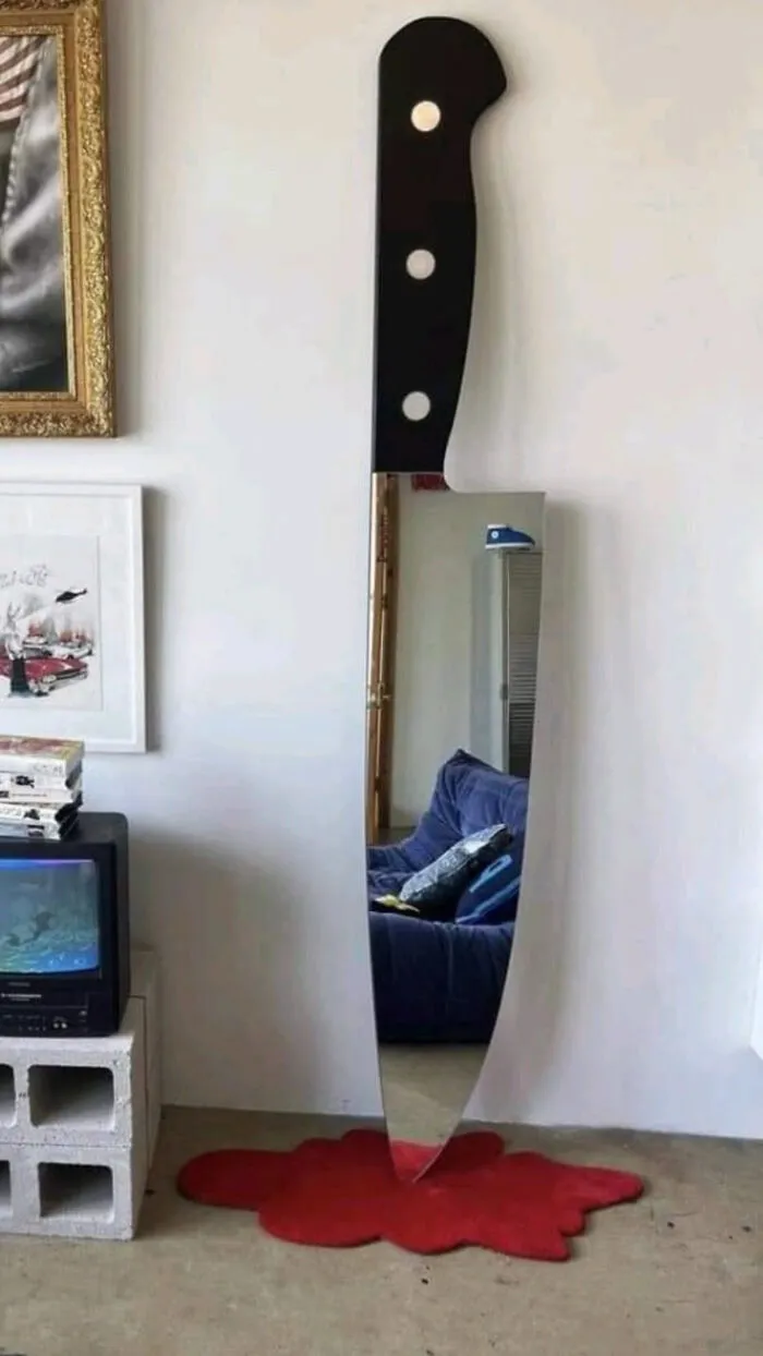 A giant knife-shaped mirror on the wall, showing bold choices in houses with a vision.