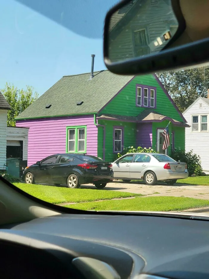 A house painted in bright green and purple, fitting the theme of houses with a vision.