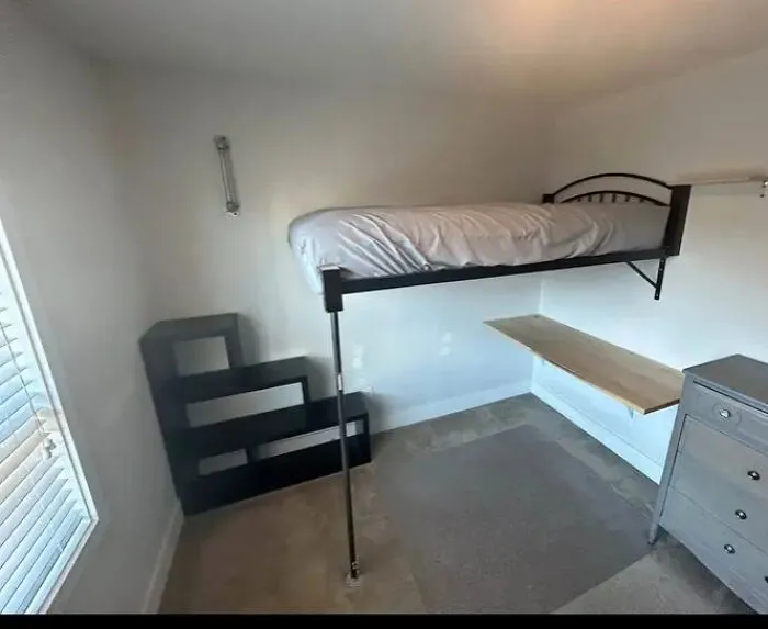 Unusual loft bed setup in a small room, showcasing houses where someone had a vision.