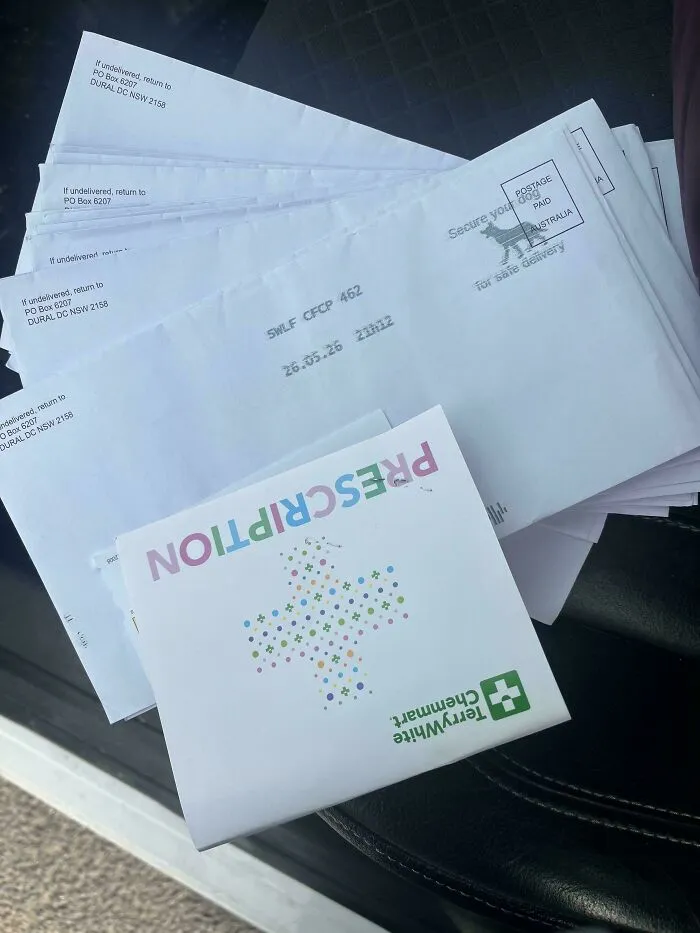 A stack of mail from a prescription pharmacy delivered to a rental address