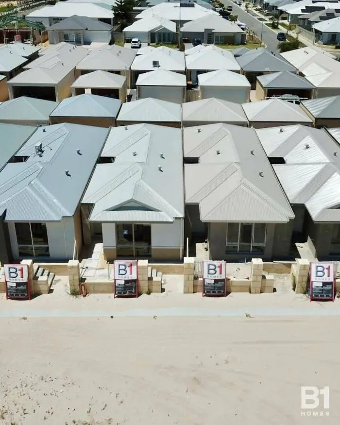 Aerial view of highly identical houses highlighting a modern suburban renting and booking estate development.
