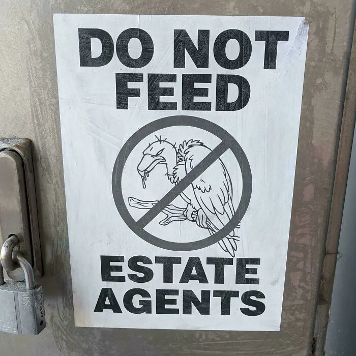 A sign saying Do Not Feed Estate Agents, showing frustrating renting and booking experiences