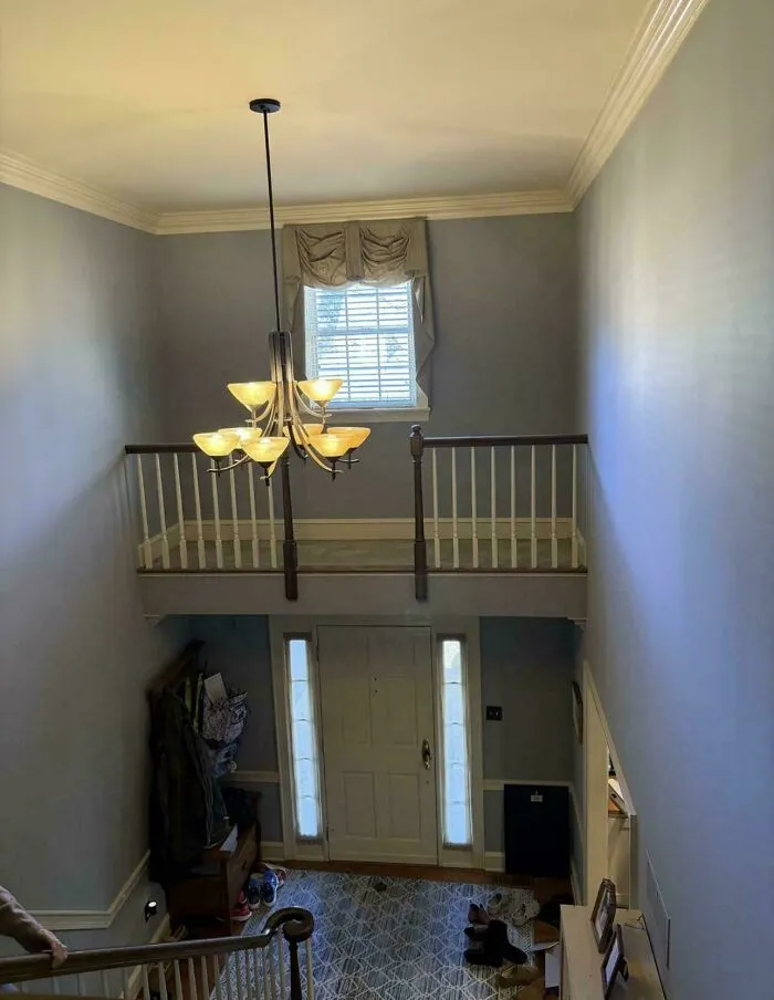 A narrow balcony in a hallway leading to nowhere, depicting houses designed with bizarre layouts.