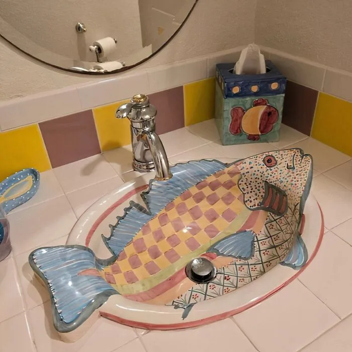 Quirky fish shaped bathroom sink with colorful patterns, a prime example of unique house designs.
