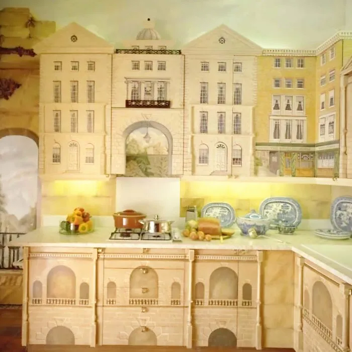 A kitchen with cabinets painted like old European buildings reflecting weird houses ideas